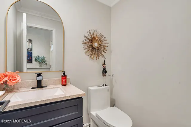 a bathroom with a sink mirror and toilet