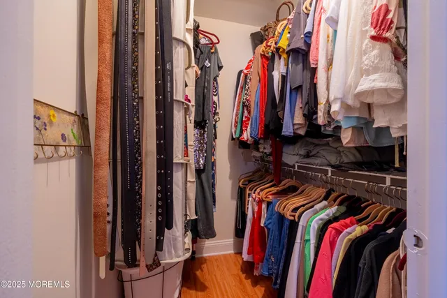 a view of walk in closet with clothes