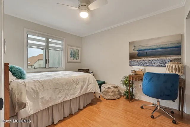 a bedroom with a bed a chair and a chandelier