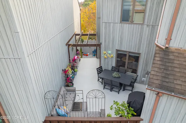 a view of a chairs and tables in the back yard of the house