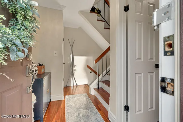 a view of entryway with furniture and wooden floor