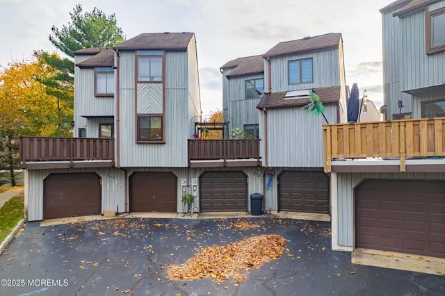 a front view of a house with a garden and plants