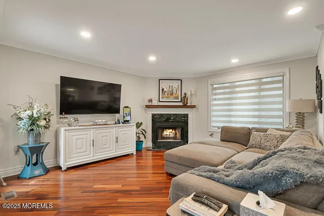 a living room with furniture flat screen tv and a fireplace
