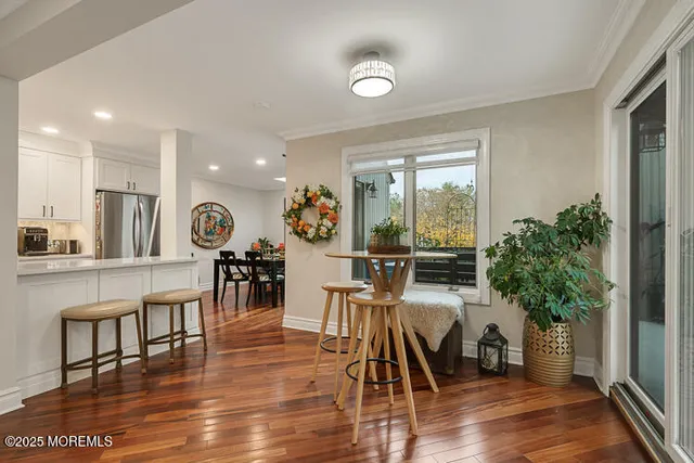 a living room with furniture and a potted plant with wooden floor