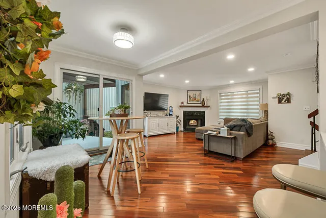 a living room with furniture kitchen view and a potted plant