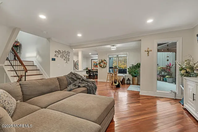 a living room with furniture and wooden floor