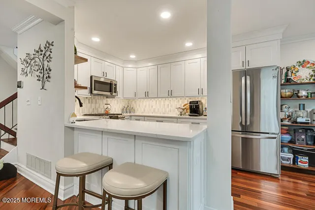 a kitchen with stainless steel appliances a refrigerator stove microwave and sink