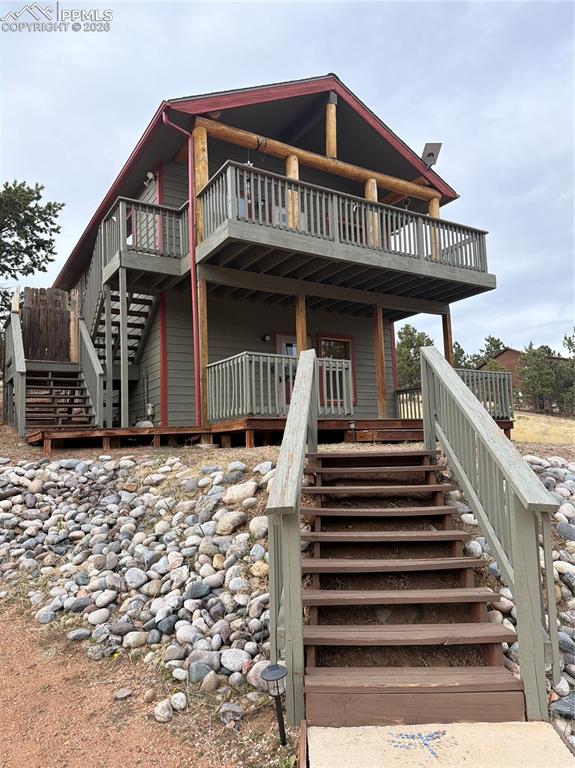 a view of a house with wooden fence