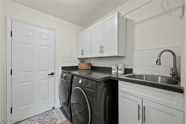 a view of a storage and utility room with washer and dryer