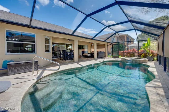 a view of a backyard with table and chairs under an umbrella