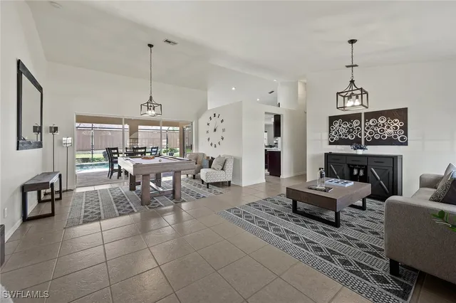 a living room with fireplace furniture and a chandelier