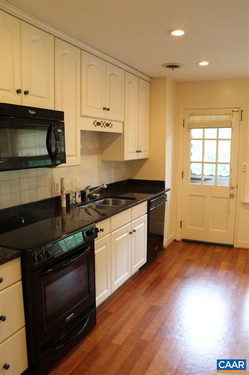 2414 Angus Road Charlottesville, VA 22901 - Photo 15 of 45 a kitchen with granite countertop wooden cabinets and a stove