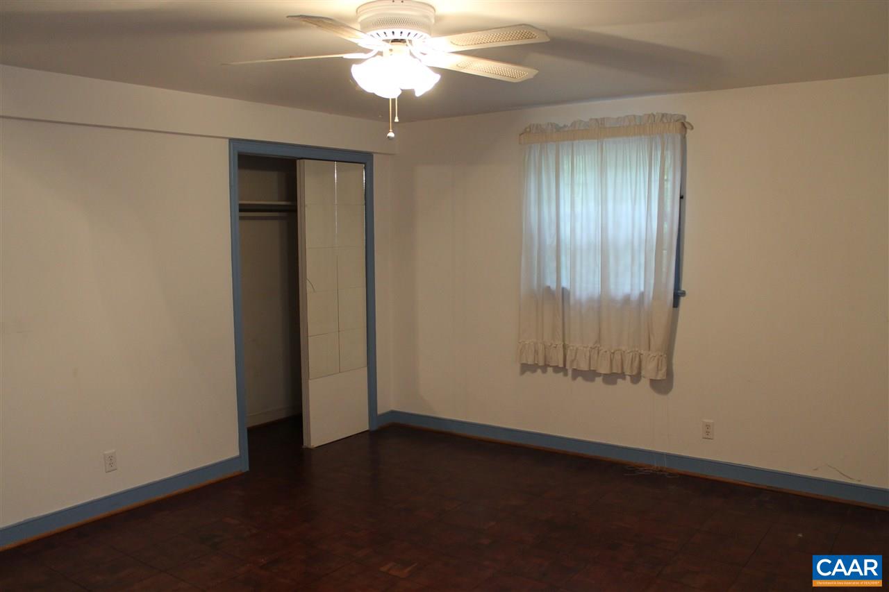 2414 Angus Road Charlottesville, VA 22901 - Photo 39 of 45 an empty room with wooden floor closet and windows