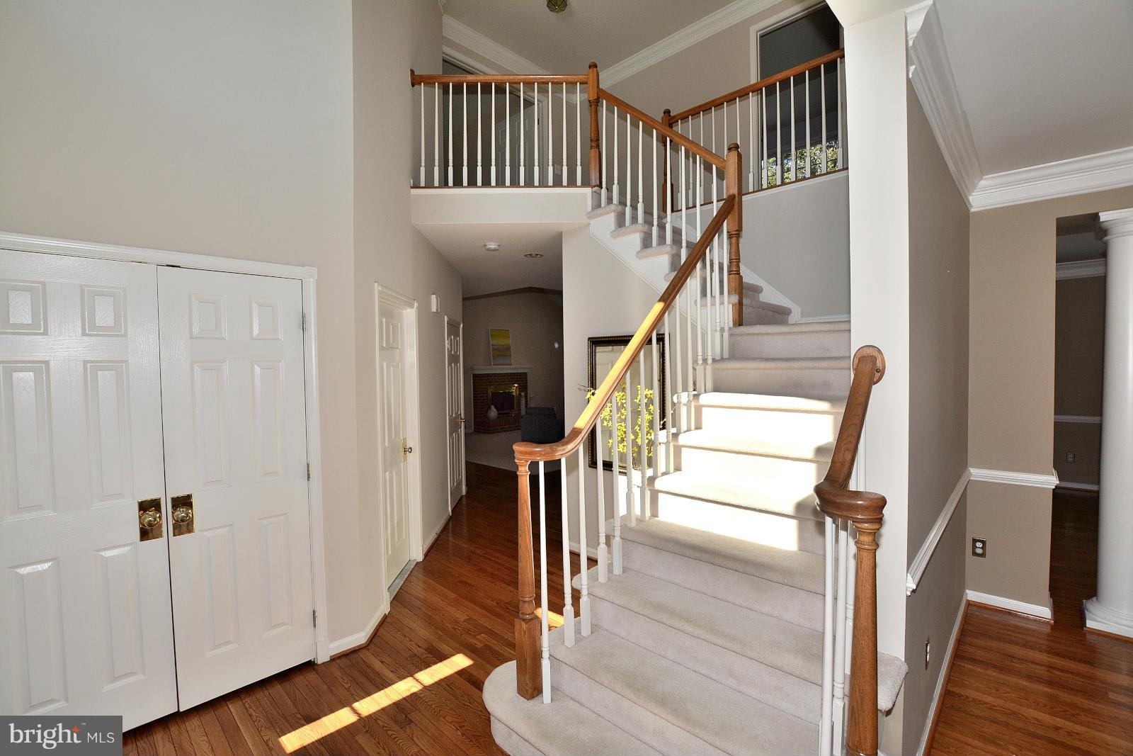 10838 Welbury Court Reston, VA 20194 - Photo 2 of 30 a view of staircase with railing and white walls