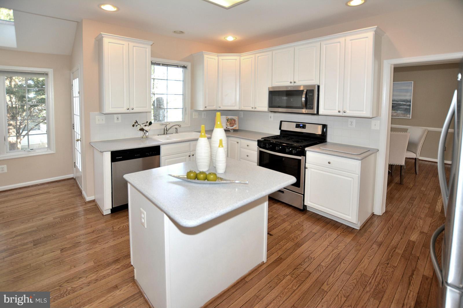 10838 Welbury Court Reston, VA 20194 - Photo 12 of 30 a kitchen with a stove a sink and a microwave