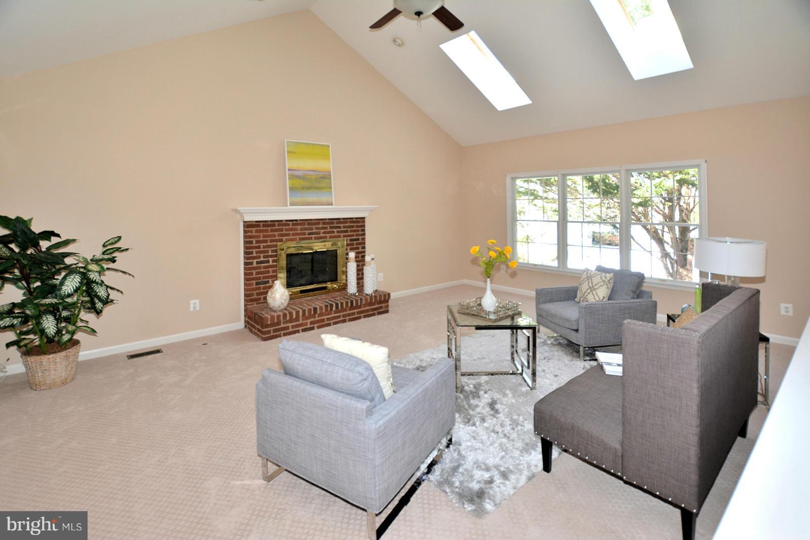 10838 Welbury Court Reston, VA 20194 - Photo 14 of 30 a living room with furniture and a fireplace