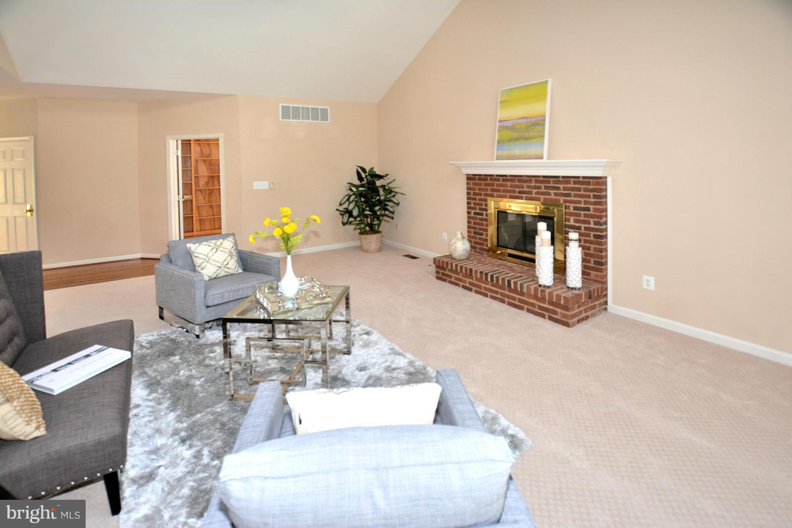 10838 Welbury Court Reston, VA 20194 - Photo 15 of 30 a living room with furniture and a fireplace