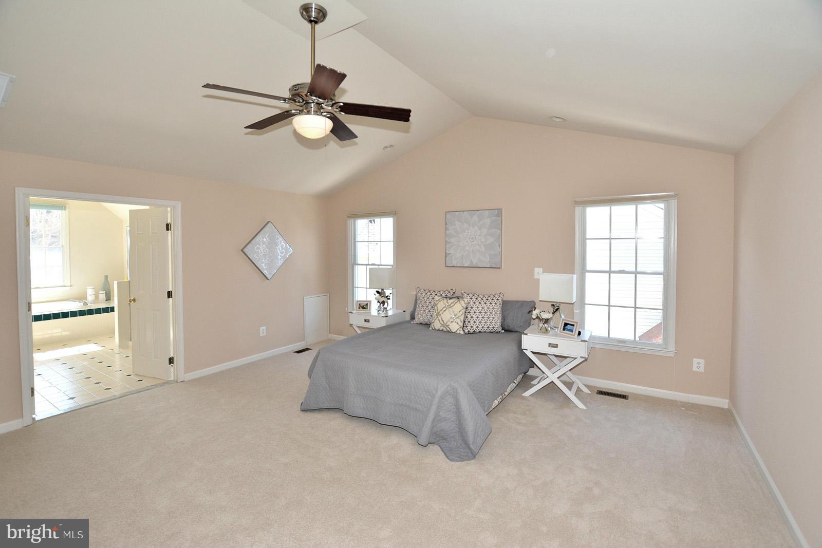 10838 Welbury Court Reston, VA 20194 - Photo 19 of 30 a spacious bedroom with a bed and window