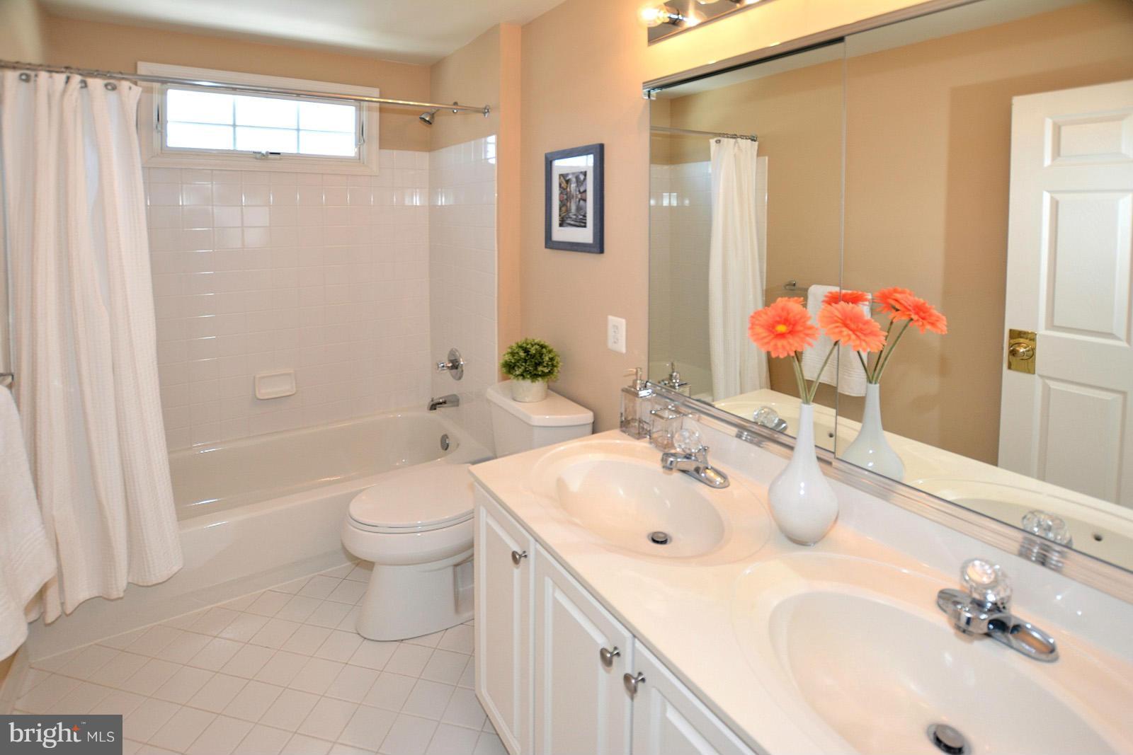 10838 Welbury Court Reston, VA 20194 - Photo 25 of 30 a bathroom with a sink and a mirror