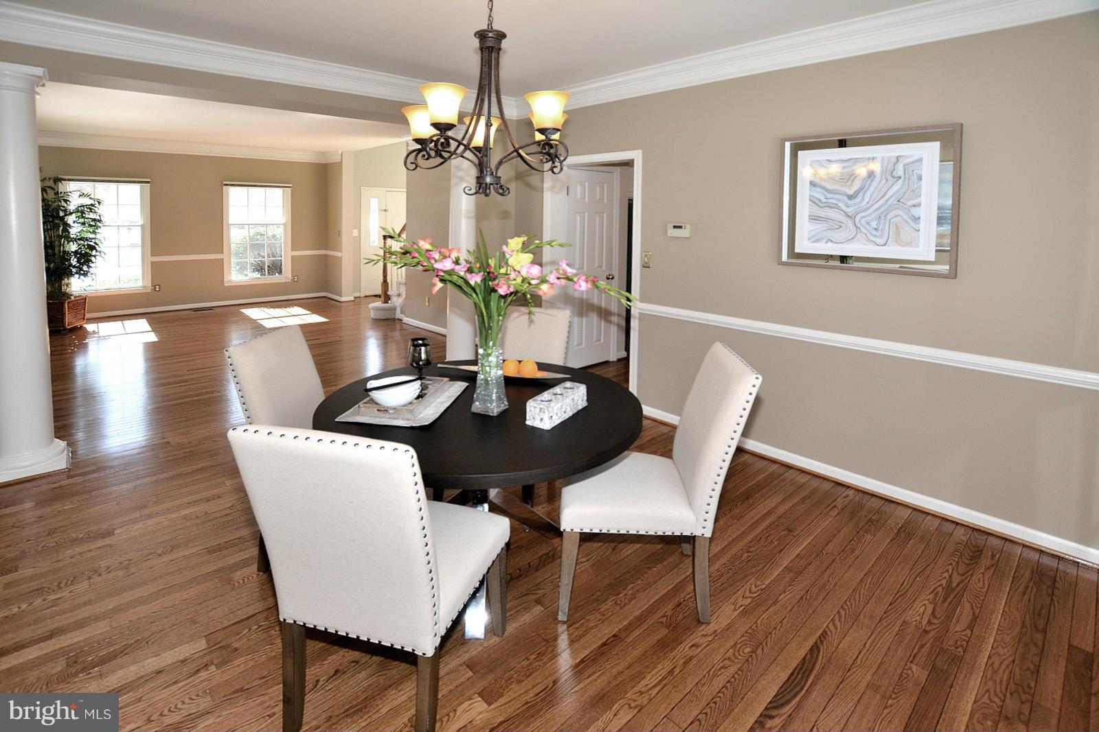 10838 Welbury Court Reston, VA 20194 - Photo 6 of 30 a view of a dining room with furniture and wooden floor