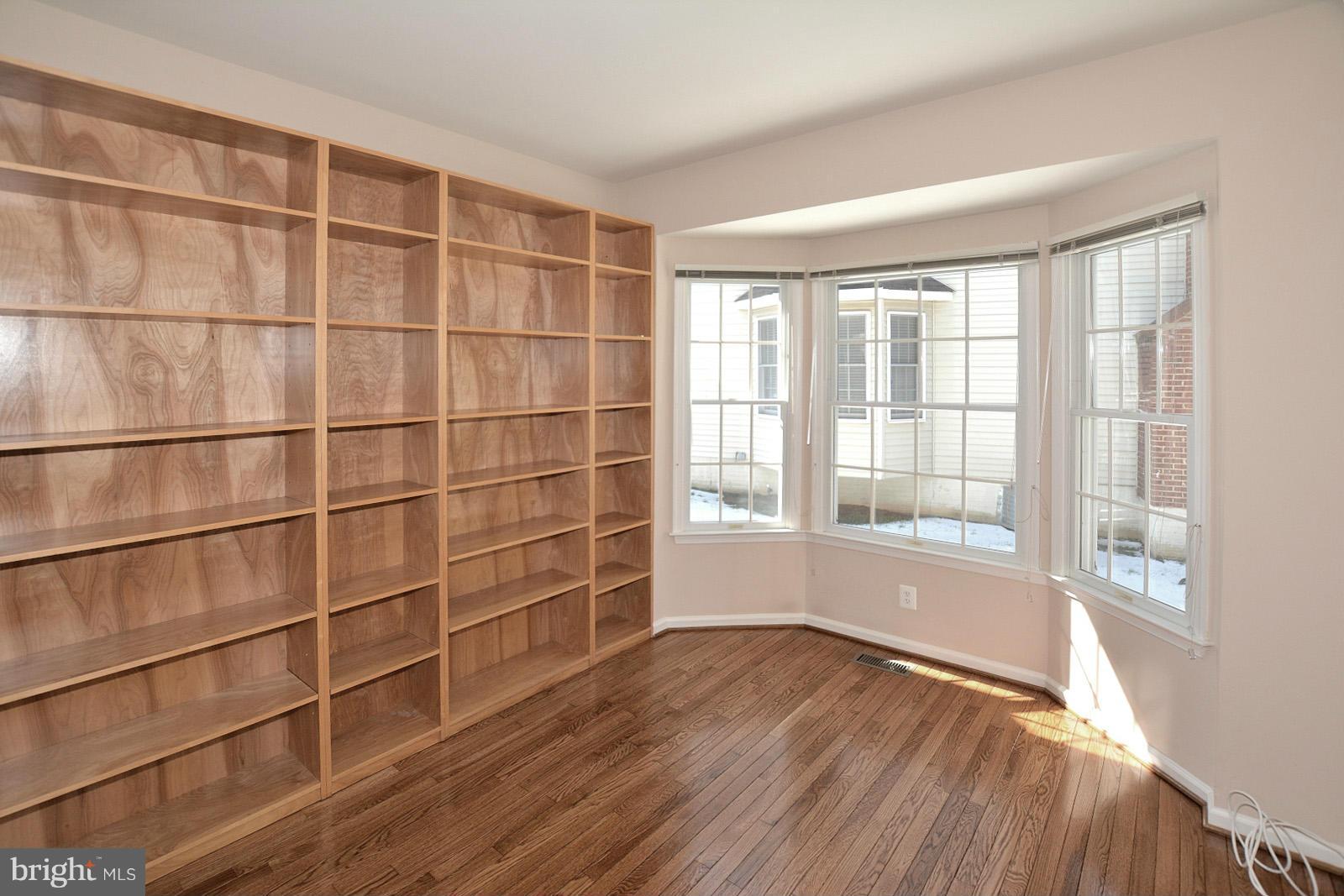 10838 Welbury Court Reston, VA 20194 - Photo 7 of 30 a view of an empty room with a window and wooden floor