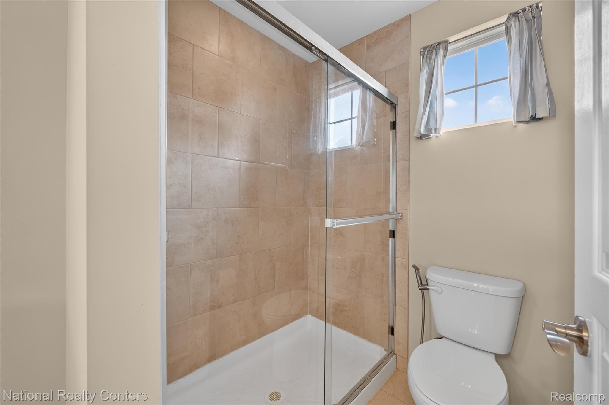 330 Glenhurst Boulevard Rochester, MI 48307 - Photo 35 of 47 Walk-in shower with clear glass enclosure, tiled walls, and white shower pan