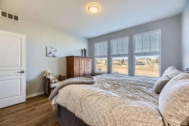 a bedroom with a bed and a large window