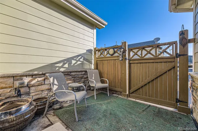 a view of a chairs and table in the backyard
