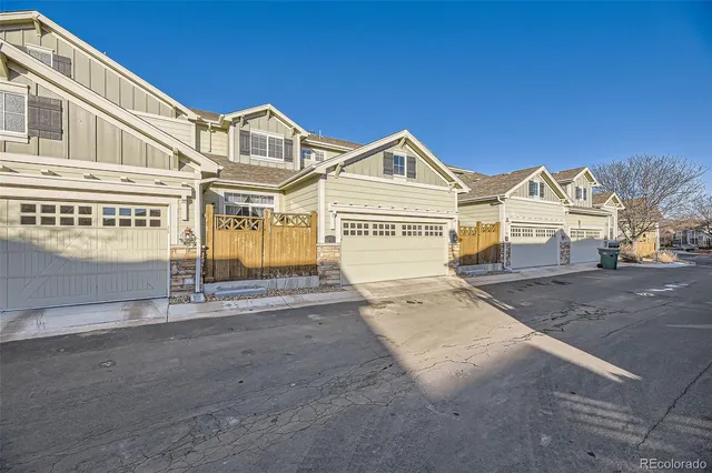 a view of a white house with a large windows next to a road
