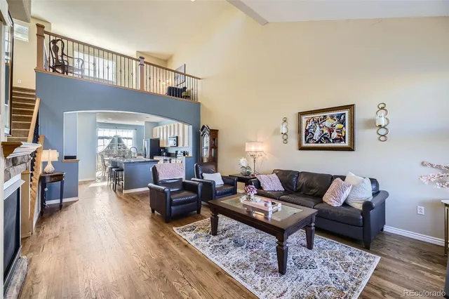 a living room with furniture wooden floor and a table