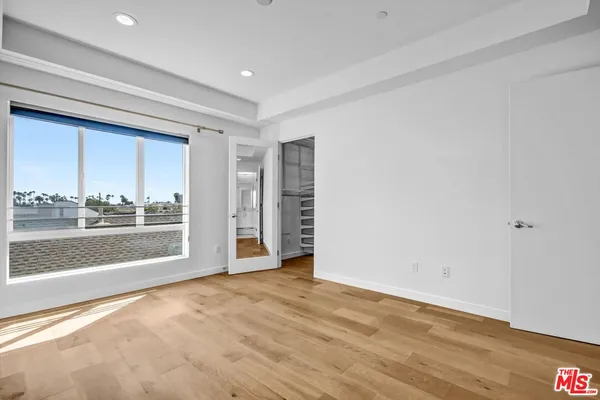 a view of workspace room with wooden floor and window