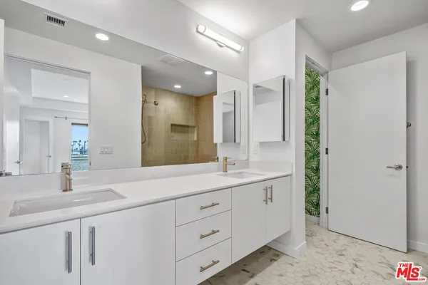 a bathroom with a double vanity sink and mirror