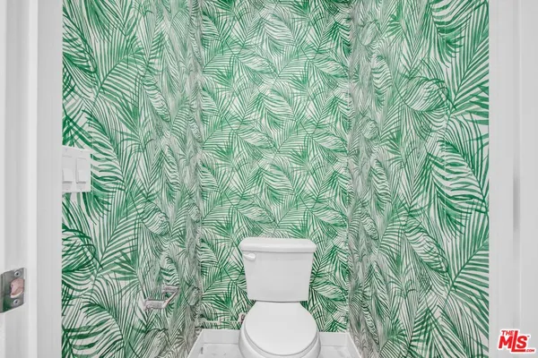 a white toilet sitting next to a shower curtain