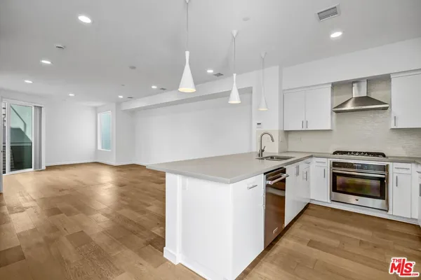 a kitchen with granite countertop a stove and a sink