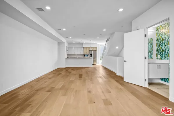 a view of a kitchen with a sink and cabinets