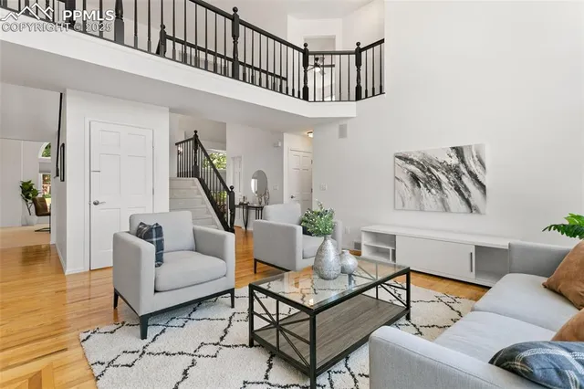 a living room with furniture and a stairs