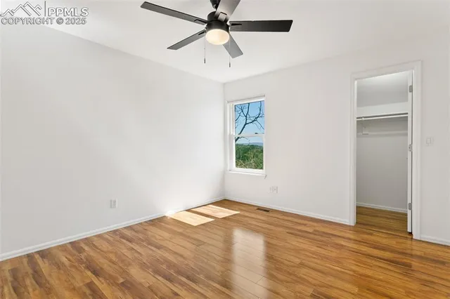 wooden floor in an empty room with a window