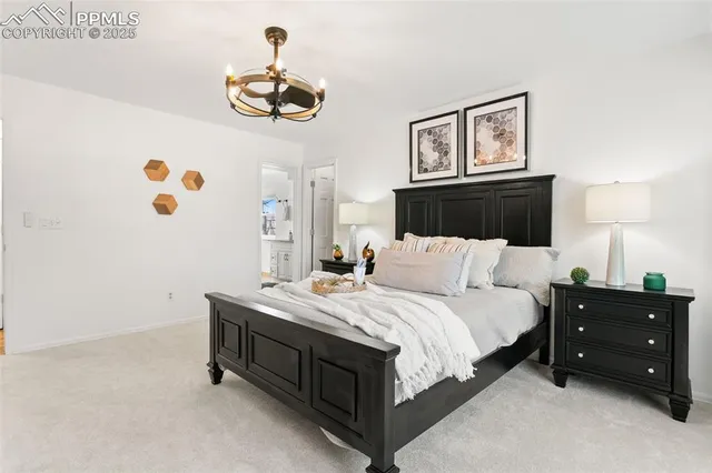 a bedroom with a bed and a chandelier