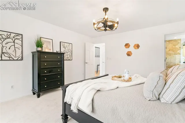 a bedroom with a bed and a chandelier