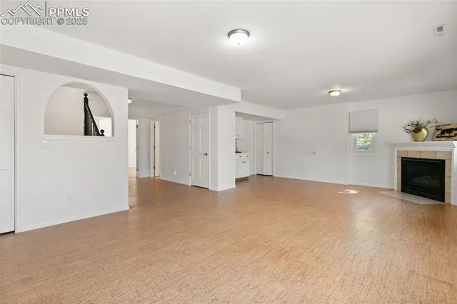a view of empty room with a fireplace