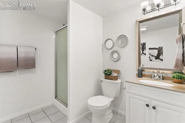 a bathroom with a toilet sink vanity and mirror