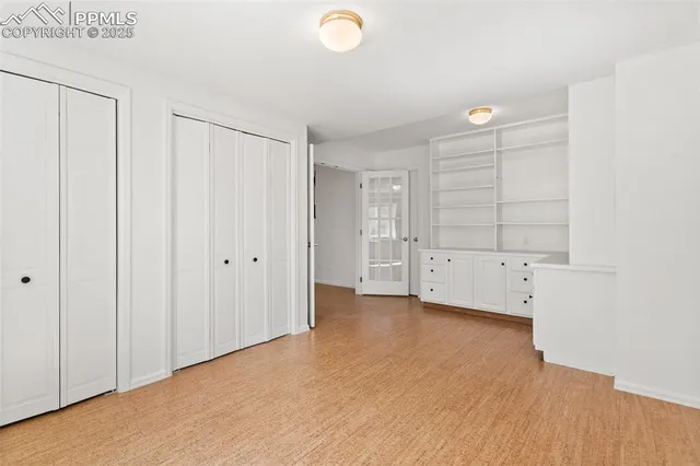 a view of an empty room and closet area