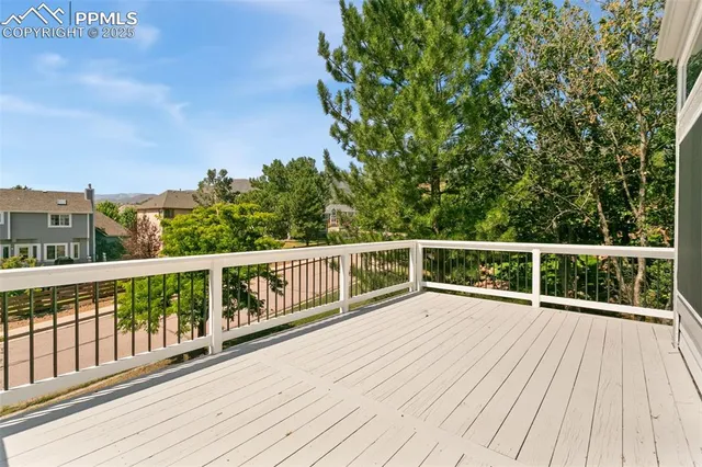 a view of balcony with wooden floor and fence
