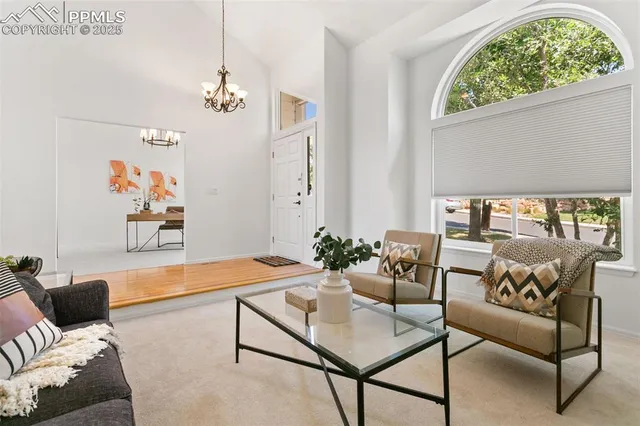 a living room with furniture and a chandelier
