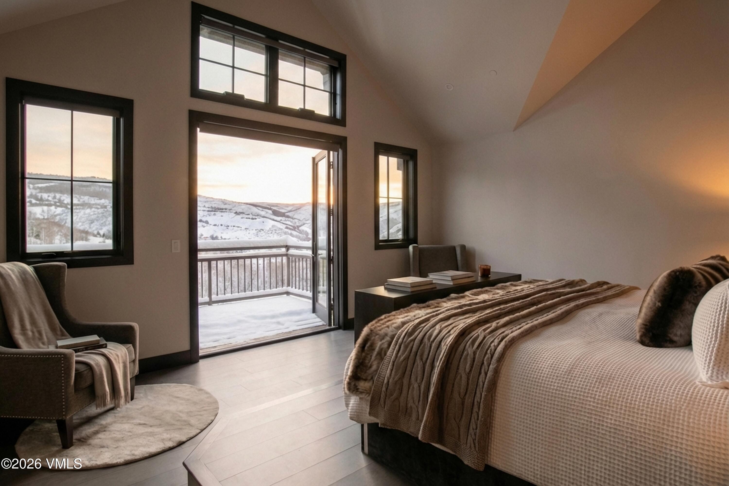 420 Little Andorra Road Edwards, CO 81632 - Photo 11 of 26 a bedroom with a bed and glass window