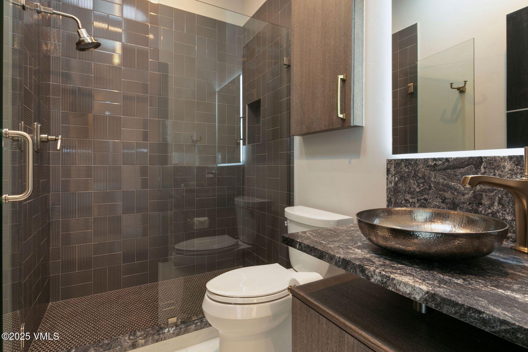 420 Little Andorra Road Edwards, CO 81632 - Photo 17 of 26 a bathroom with a granite countertop toilet and a sink