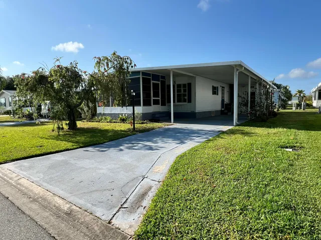 a front view of a house with a yard and porch