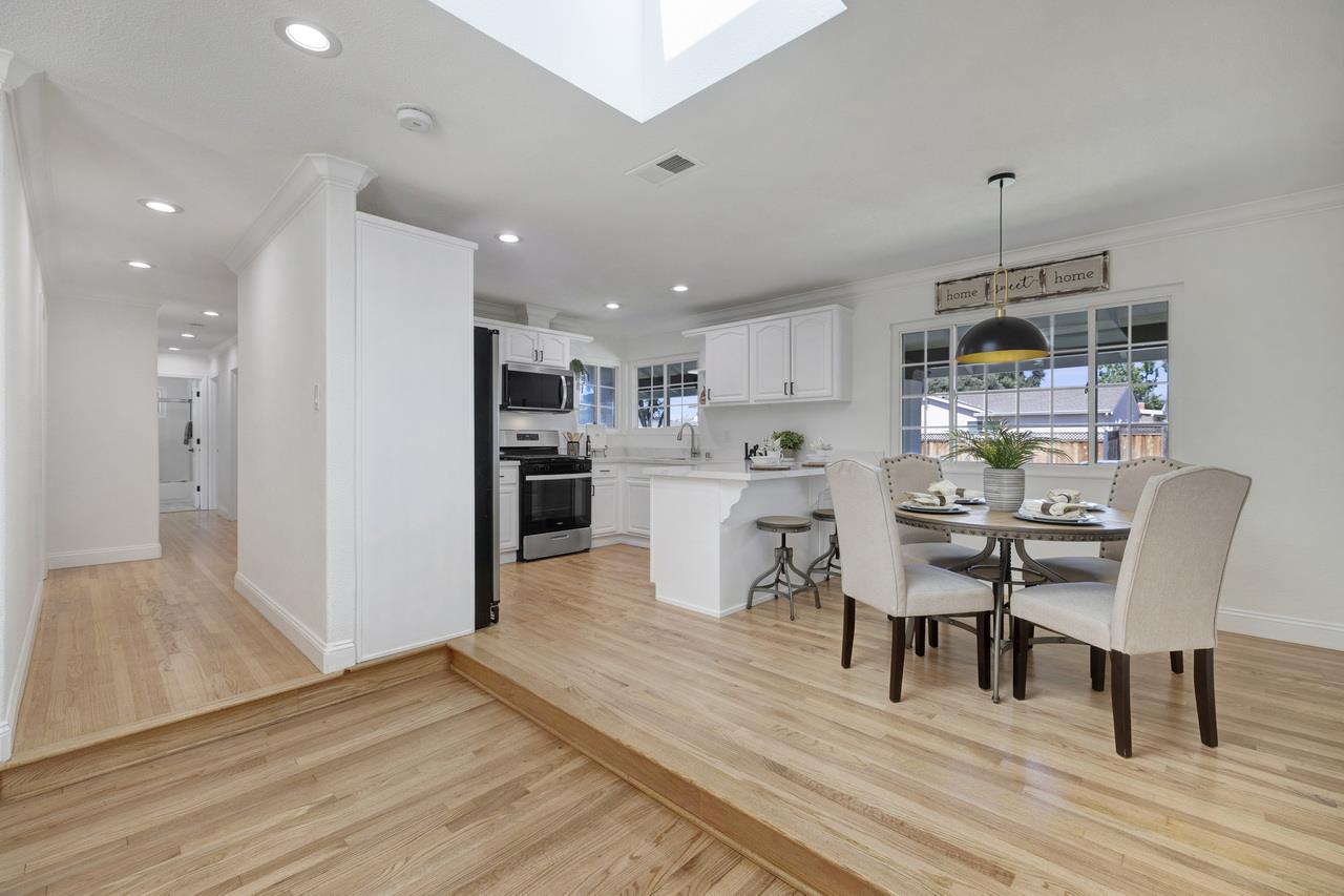 1075 Summerfield Drive San Jose, CA 95121 - Photo 11 of 38 a dining room with kitchen island stainless steel appliances furniture a dining table and chairs