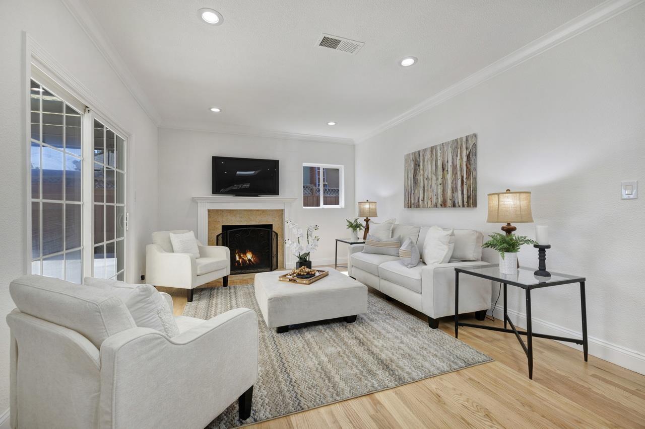 1075 Summerfield Drive San Jose, CA 95121 - Photo 7 of 38 a living room with furniture a fireplace and a flat screen tv