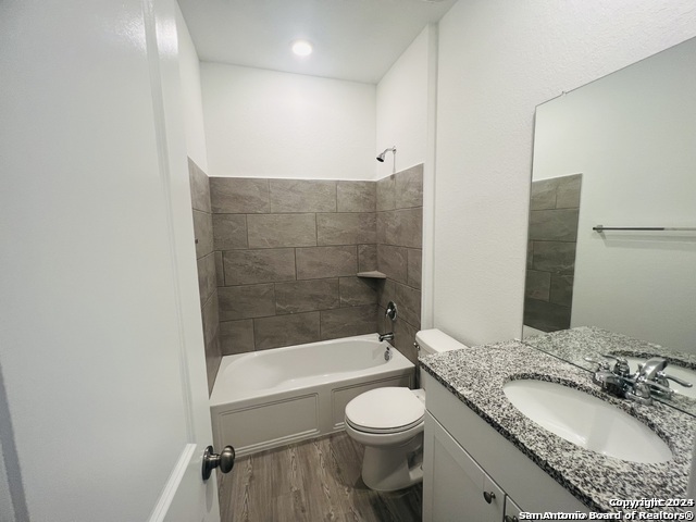 32141 Morels Avenue Bulverde, TX 78163 - Photo 20 of 22 a bathroom with a granite countertop sink toilet and shower